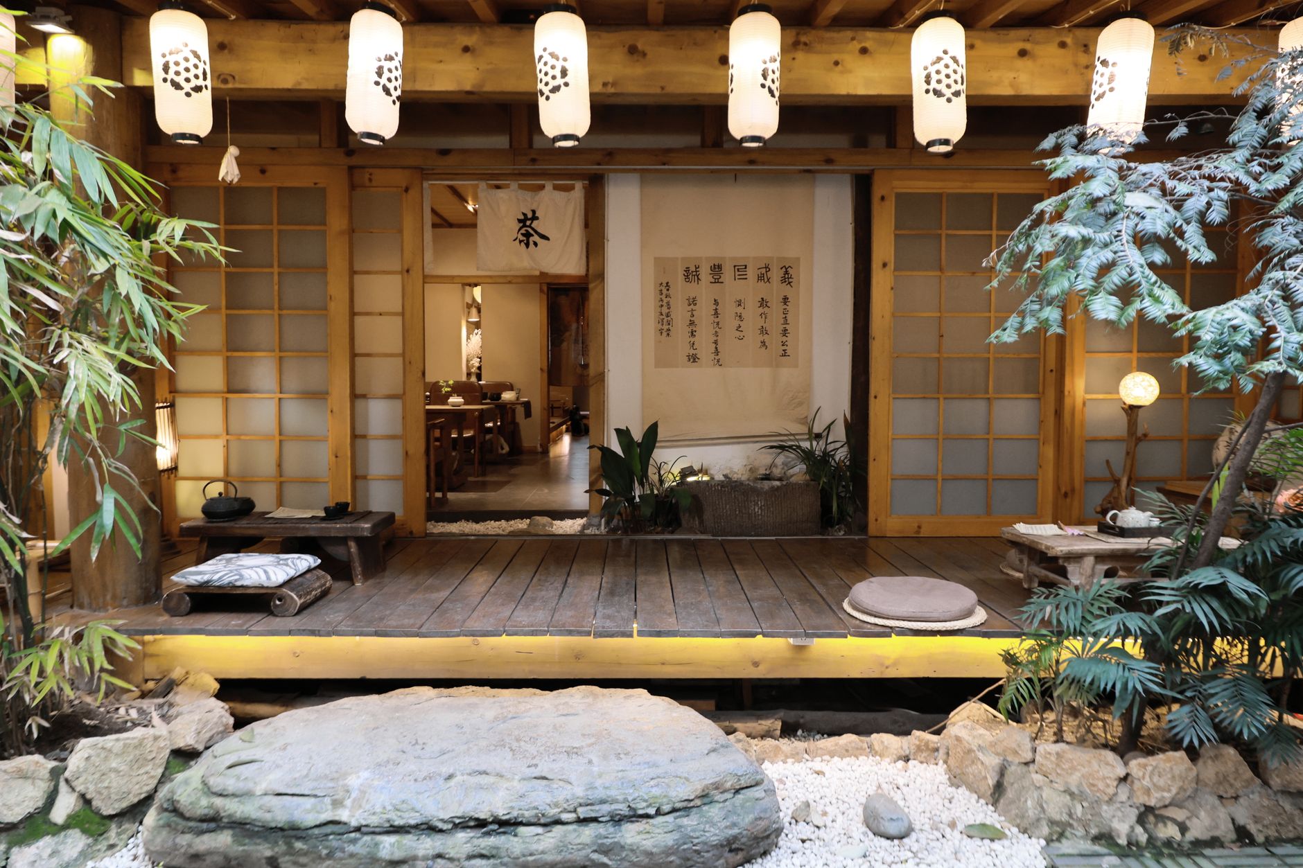 Teahouse wooden interior overlooking wet bamboo garden